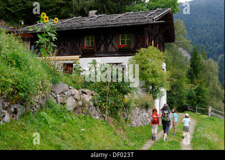 Hiker walking in front of a farmhouse, Bad Dreikirchen near Barbian, Eisack Valley, province of Bolzano-Bozen, Alto Adige, Italy Stock Photo
