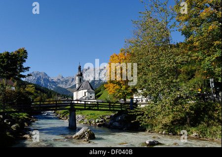 Parish Church of Saint Sebastian and the Ramsau river in front of the Reiteralpe or Reiter Alm mountains, Ramsau Stock Photo