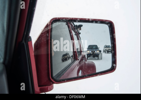 Super Jeep in a winter landscape, view in the rearview mirror, Vatnajoekull Glacier, Icelandic Highlands, Iceland, Europe Stock Photo