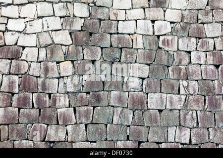 Stone wall of a traditional Japanese castle. Stock Photo