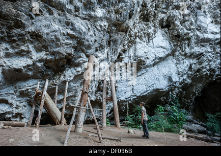 Woman admiring thousands of years old teak coffins, tomb within a cave, Soppong or Pang Mapha area, Mae Hong Son province Stock Photo