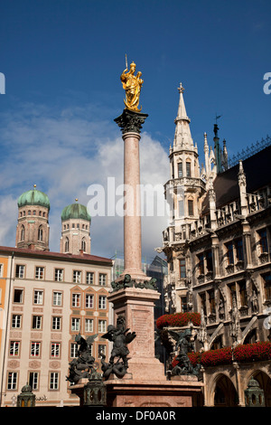 Virgin Mary atop the Mariensaeule, neues Rathaus and the church towers of the Frauenkirche in Munich, Bavaria, Germany Stock Photo