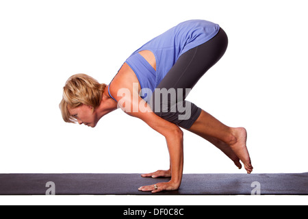 Young Woman Doing Crane Yoga Pose