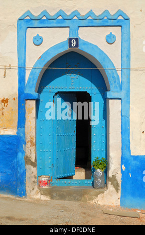 Typically shaped blue door on a white facade in Sidi Ifni, Morocco, Africa Stock Photo