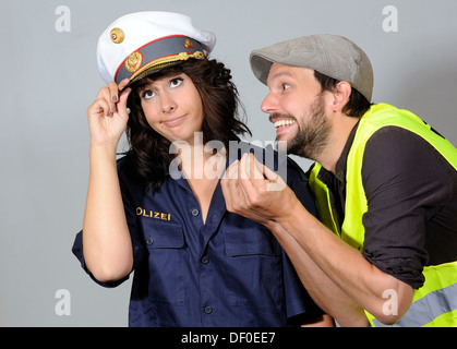 Woman dressed as a police officer and a man, symbolic image for a breakdown Stock Photo