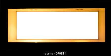 Long rectangular blank white sign or name plaque in a wooden frame isolated on a black background with copyspace for your text Stock Photo