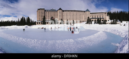 Canada, Banff National Park, Ice Skaters on Lake Louise in Banff national park in Western Canada. Stock Photo