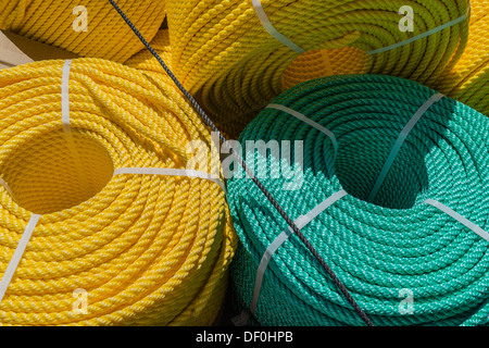 A close-up of yellow and aqua nylon coiled ropes for marine use. Stock Photo