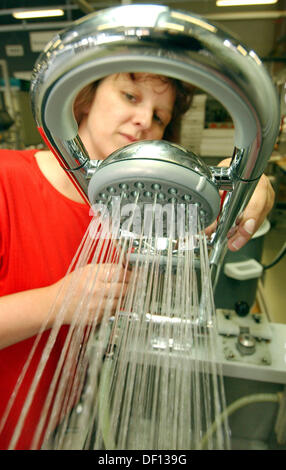 (FILE) An archive photo dated 13 September 2004 shows employee Carmen Mueller checking a shower by Marke Freehander at the Grohe Water Technology AG & Co KG in Herzberg, Germany. Lixil together with the Development Bank of Japan acquired 87.5 percent of the stock, according to Grohe on Thursday in Duesseldorf. Photo: PATRICK PLEUL Stock Photo