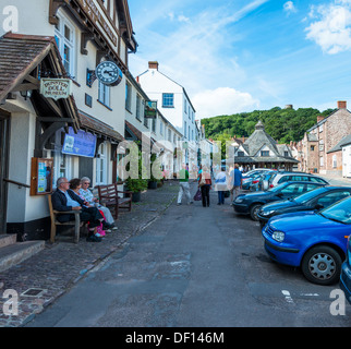 Dunster, Somerset,England, UK. The main street of Dunster showing the Yarn Market, Dunster Doll Museum and tourists Stock Photo