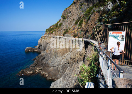 Woman Reading Sign at the Closed Via dell Amore in Riomaggiore in 2013 Cinque Terre Liguria Italy Stock Photo