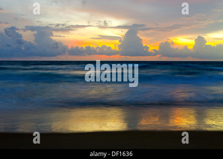 Sunset on the horizon at Karen Beach on Phuket Island, Thailand Stock Photo