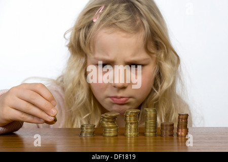 Berlin, Germany, little girl counts her allowance Stock Photo