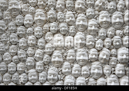 Many heads of plaster on a door, DOOR LOCK, decoration in Funchal, Madeira Stock Photo