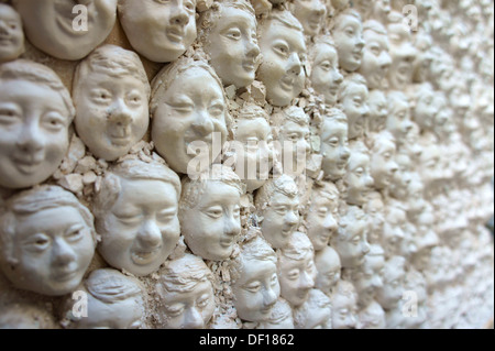 Many heads of plaster on a door, DOOR LOCK, decoration in Funchal, Madeira Stock Photo