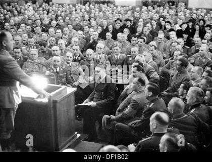 The image from the Nazi Propaganda! shows Adolf Hitler among his 'old comrades' during an hour of commemoration on the occasion of the anniversary of the Beer Hall Putsch of 9 November 1923 in Löwenbräukeller in Munich, Germany, on 9 November 1934(?). Personalities: at the speaker's desk Gauleiter Paul Giesler. To Hitler's right: Hermann Göring, behind him (at the table, partially covered): Joseph Goebbels, Robert Ley, Max Amann, Hermann Esser. Behind the table (r-l): Wilhelm Schepman, Karl Fiehler, Franz Xaver Schwarz. In Front of Schwarz, Konstantin Hierl, to the left Franz Ritter von Epp an Stock Photo