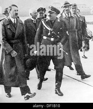 The image from the Nazi Propaganda! shows Adolf Hitler with NSDAP city councilman Christian Weber upon his arrival at the airport in Munich, Germany, in January 1934. Fotoarchiv für Zeitgeschichte Stock Photo