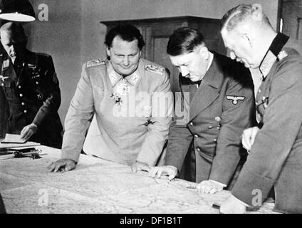 The image from the Nazi Propaganda! shows Adolf Hitler reviewing the military situation in the command bunker of Göring in Potsdam, Germany, date unknown. (to the right, Major General Josef 'Beppo' Schmid) Fotoarchiv für Zeitgeschichte Stock Photo