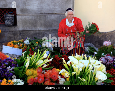 Madeira, Funchal, in Camara Flower Seller-dress at the market hall Stock Photo