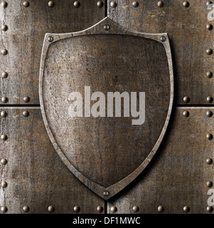 old metal shield over armour background with rivets Stock Photo