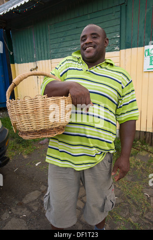 Man selling peanuts from a basket, Little Bay, Montserrat Stock Photo