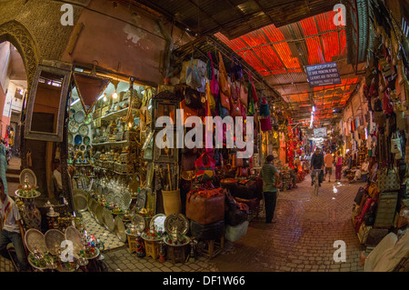 Shops selling leather bags and silverware on a cobbled alleyway in the souk, Marrakech, Morocco Stock Photo