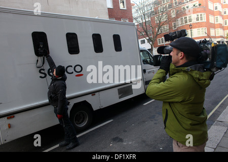 British press photographers take photographs of a prison van as Wikileaks founder Julian Assange is expected to arrive at Magist Stock Photo