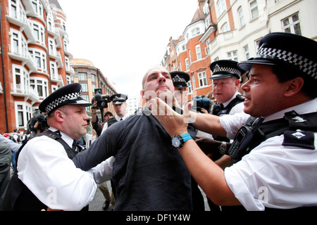 Police arrest a supporter of Wikileaks founder Julian Assange who sought political asylum outside at the Ecuadorian embassy of a Stock Photo