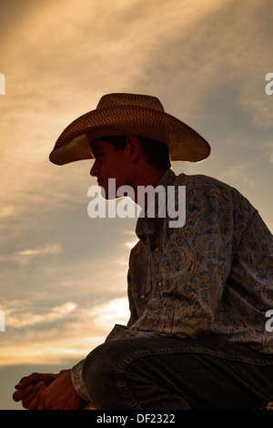 Portrait of a cowboy working at Rimrock rodeo, Grand Junction, Colorado, USA taken at sunset Stock Photo