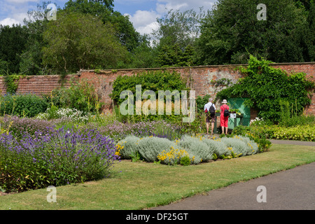 Two visitors admiring the planting, Walled Garden, Delapre Abbey, Northampton, UK Stock Photo
