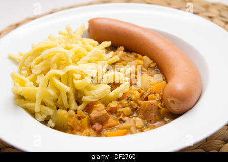 Lentils with spaetzle (noodles) and frankfurter sausage Stock Photo