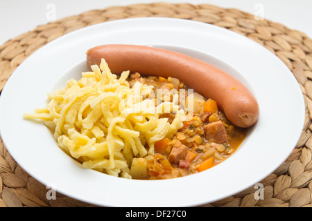 Lentils with spaetzle (noodles) and frankfurter sausage Stock Photo