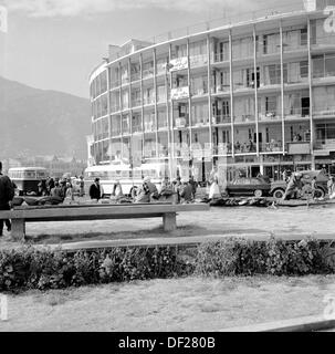 Historical picture from 1950s by J Allan Cash of a semi-circular hotel building and traffic, Kabul, Afghanistan. The 1950s and 60s was a relatively peaceful time for the country, which saw a number of new, modern buildings constructed, as seen in the picture and efforts made towards modernisation and making the country a more open, prosperous society. This came to end in the 1970s with invasions, coups and civil wars. Stock Photo