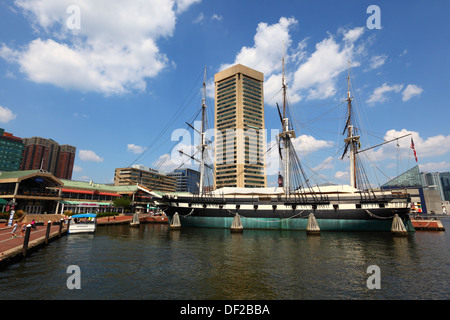 USS Constellation, World Trade Center building in background, Inner Harbor, Baltimore City, Maryland, USA Stock Photo
