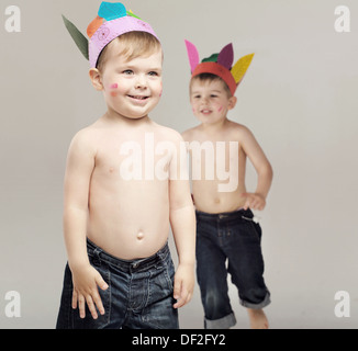 Two little brothers acting as Indians Stock Photo