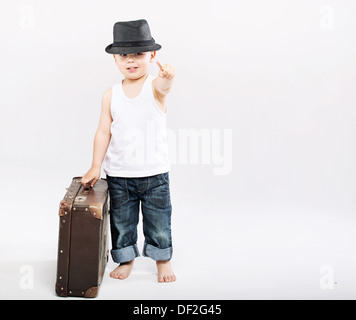 Little gentleman with huge brown suitcase Stock Photo