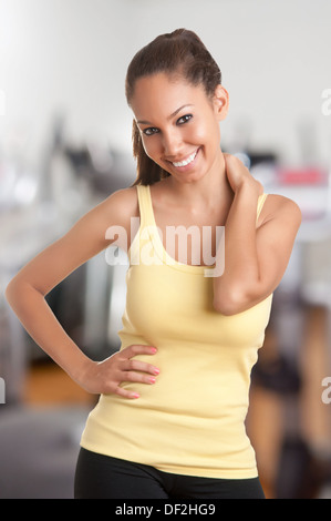 Fit woman standing and relaxing after a workout in a gym Stock Photo