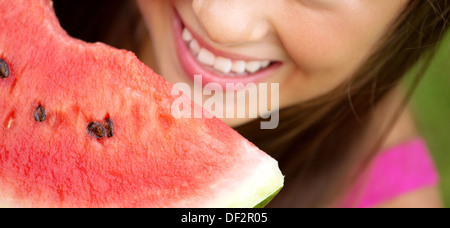Fine picture presenting cute girl eating a watermelon Stock Photo