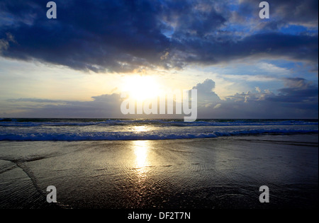 Sunset on the horizon at Karen Beach on Phuket Island, Thailand Stock Photo