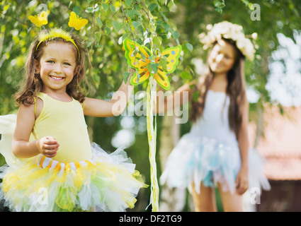 Two laughing cute sisters at the garden Stock Photo