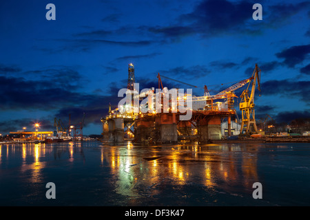 Oil rig at night in winter scenery. Stock Photo