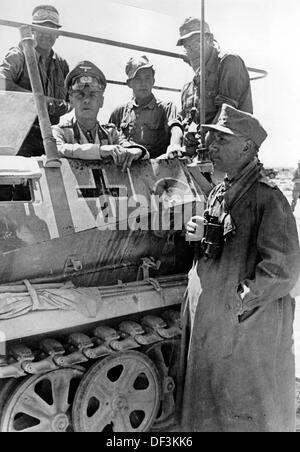 Field Marshal Erwin Rommel (2-l) is pictured on the ground during the occupation of Tobruk in June 1942. The Nazi Propaganda! on the back of the image is dated 22 June 1942: 'The battle of Tobruk. The conqueror of Tobruk, Field Marshal Rommel, on the battlefield.' Fotoarchiv für Zeitgeschichte Stock Photo