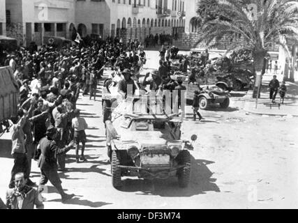 The image from the Nazi Propaganda! depicts soldiers of the German Wehrmacht as they are welcomed by the Italian population in Bengasi, Libya, published on 18 April 1941. Fotoarchiv für Zeitgeschichte Stock Photo