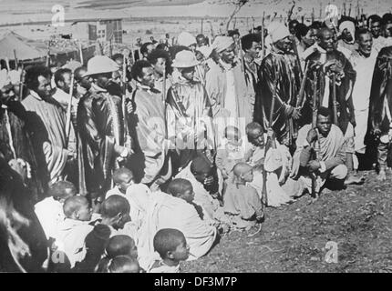 The image from the Nazi Propaganda! depicts local men and children with weapons in Ethiopia, published 20 November 1940. The text on the back of the image reads: 'An image from Gonder (East Africa), which is heorically defended by the Italians. A motion of confidence by the locals of Gonder on the anniversary of the March on Rome.' Fotoarchiv für Zeitgeschichte Stock Photo