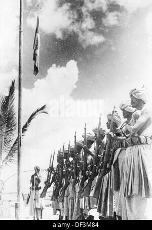 The image from the Nazi Propaganda! depicts colonial soldiers of the Italian troops - so-called 'dubats' - during a flag parade in North Africa, published on 2 January 1941. Place unknown. Fotoarchiv für Zeitgeschichte Stock Photo