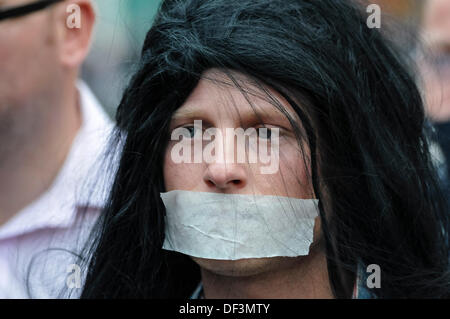 Belfast, Northern Ireland, 27th September 2013 - Jamie Bryson wears a wig and tape across his mouth as he accompanies Protestant Coalition founder member Willie Frazer as he appears in court dressed as Abu Hamza. Credit:  Stephen Barnes/Alamy Live News