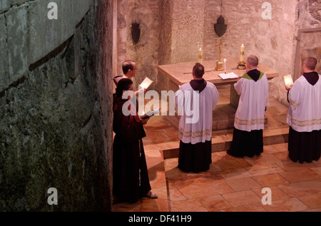 Franciscan priests taking part in a Roman Catholic mass procession  inside the Church of Holy Sepulchre in the Christian Quarter old city East Jerusalem Israel Stock Photo