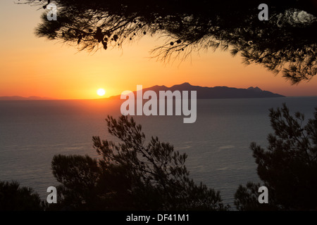 Sunrise over the Aegean as seen from Kamari on Santorini. The island in the distance is Anafi. 2013. Stock Photo