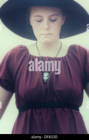 a sad young girl with black sunhat Stock Photo