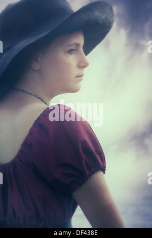 a sad young girl with black sunhat Stock Photo